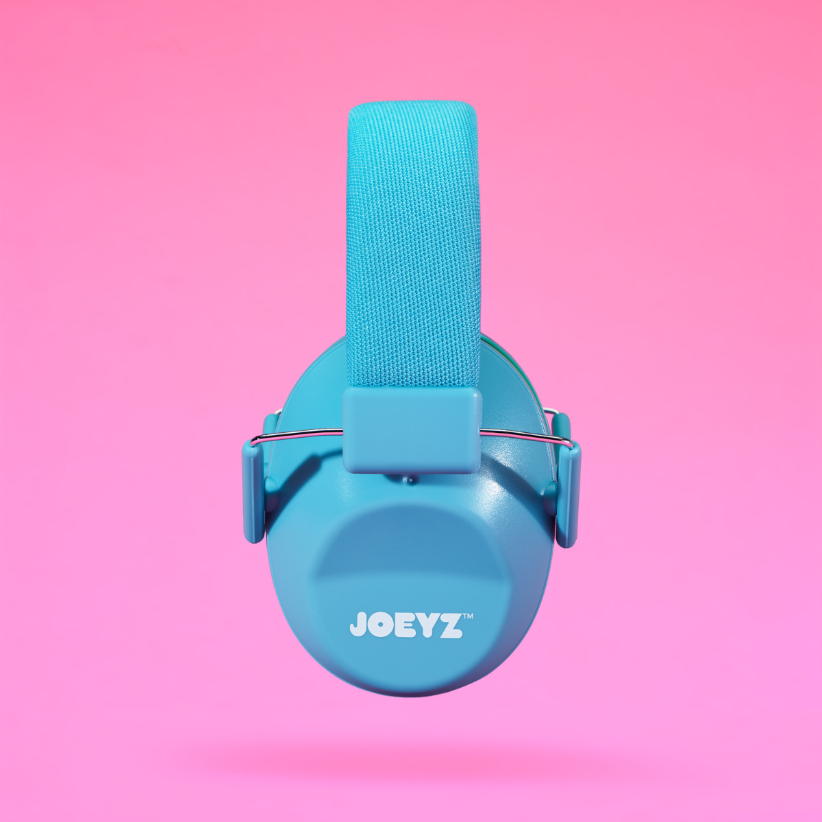 A light blue Joeyz child safety headphone with a fabric head strap, shown from the back against a solid pink background.